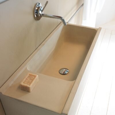 ELLE line washbasins in cement finish mortar, available in grey, white, and sand tones, offering handcrafted elegance