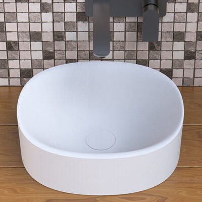 Close-up of the Round CLIFF washbasin by Ideavit, featuring a minimalist design with a matching matte white drain cover