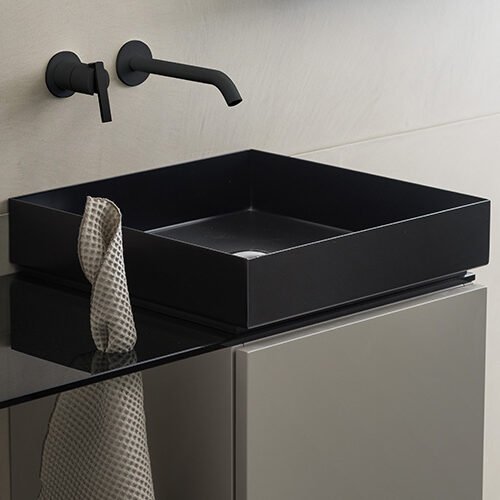 Modern square washbasin crafted from white solid surface and supported by a stainless steel frame