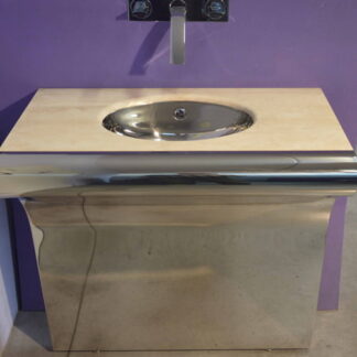 Stainless steel console with a curved front, light travertine counter, and integrated oval sink