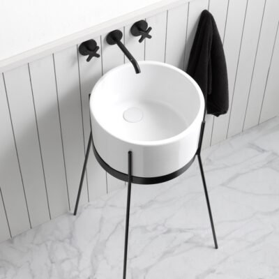 IBRIDO Round Pedestal Sink with a pristine white ceramic basin and sleek black metal pedestal