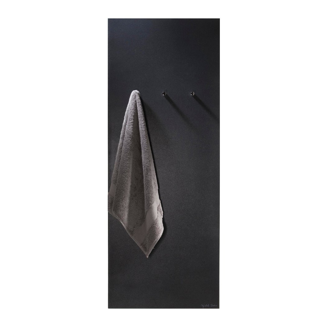 The Ateliers CINIER Minimal bath towel warmer radiator in matte black and white finish, highlighting its large heating surface and innovative Olycal® stone