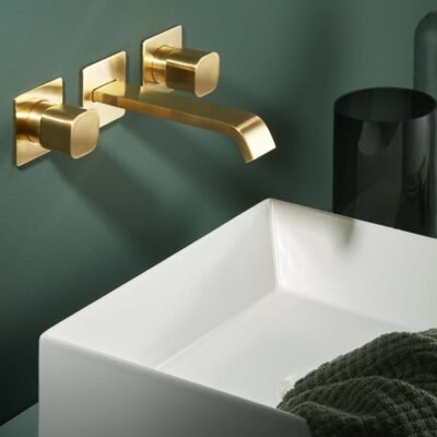 The TAORMINA luxury wall-mounted faucet by Ritmonio features a brushed gold finish and is designed to bring elegance and functionality to any bathroom