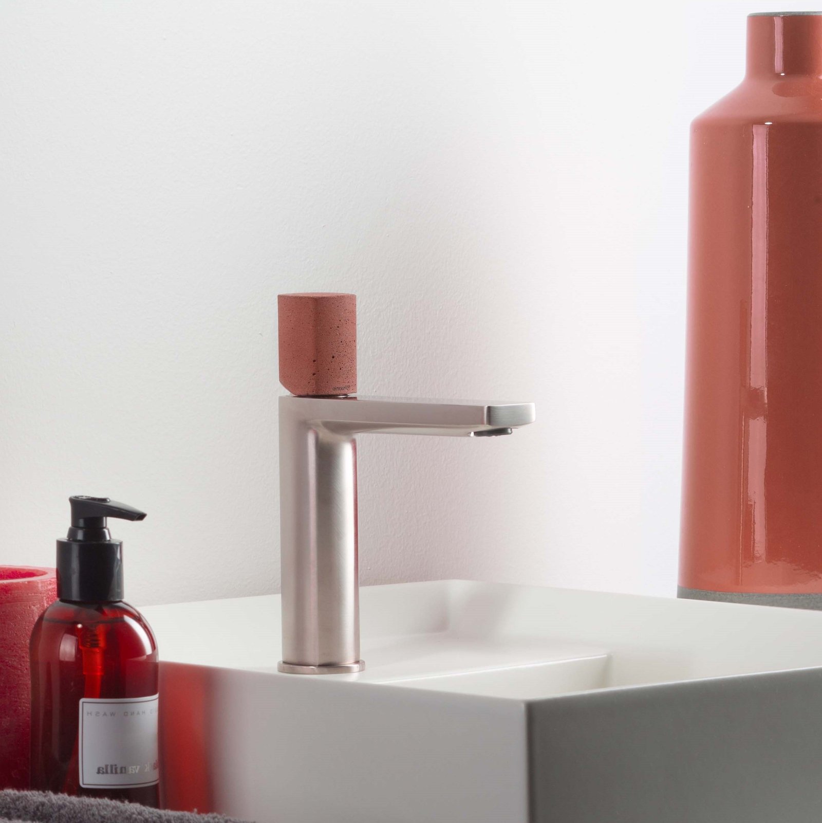 The HAPTIC designer bathroom faucet by Ritmonio, offering ergonomic design and water-saving technology, available in various finishes like polished chrome, satin nickel, matte black, and more