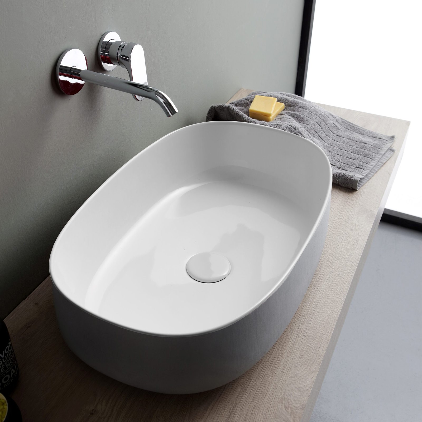 Soft-shaped oval ceramic washbasin Soft-shaped oval ceramic washbasin inspired by nature, featuring Bucchero's craftsmanship
