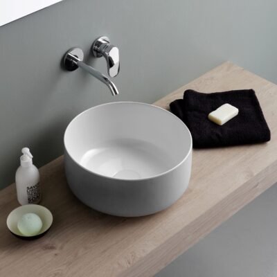 Elegant Bucchero round ceramic washbasin crafted with innovative materials