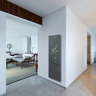 CINIER Corsica bath towel warmer radiator with a sleek anthracite grey finish, combining luxury design with energy-efficient Olycal® stone technology