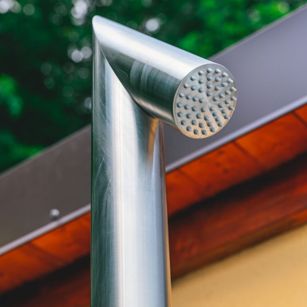 Modern outdoor shower column featuring a foot jet and intuitive hot and cold water controls