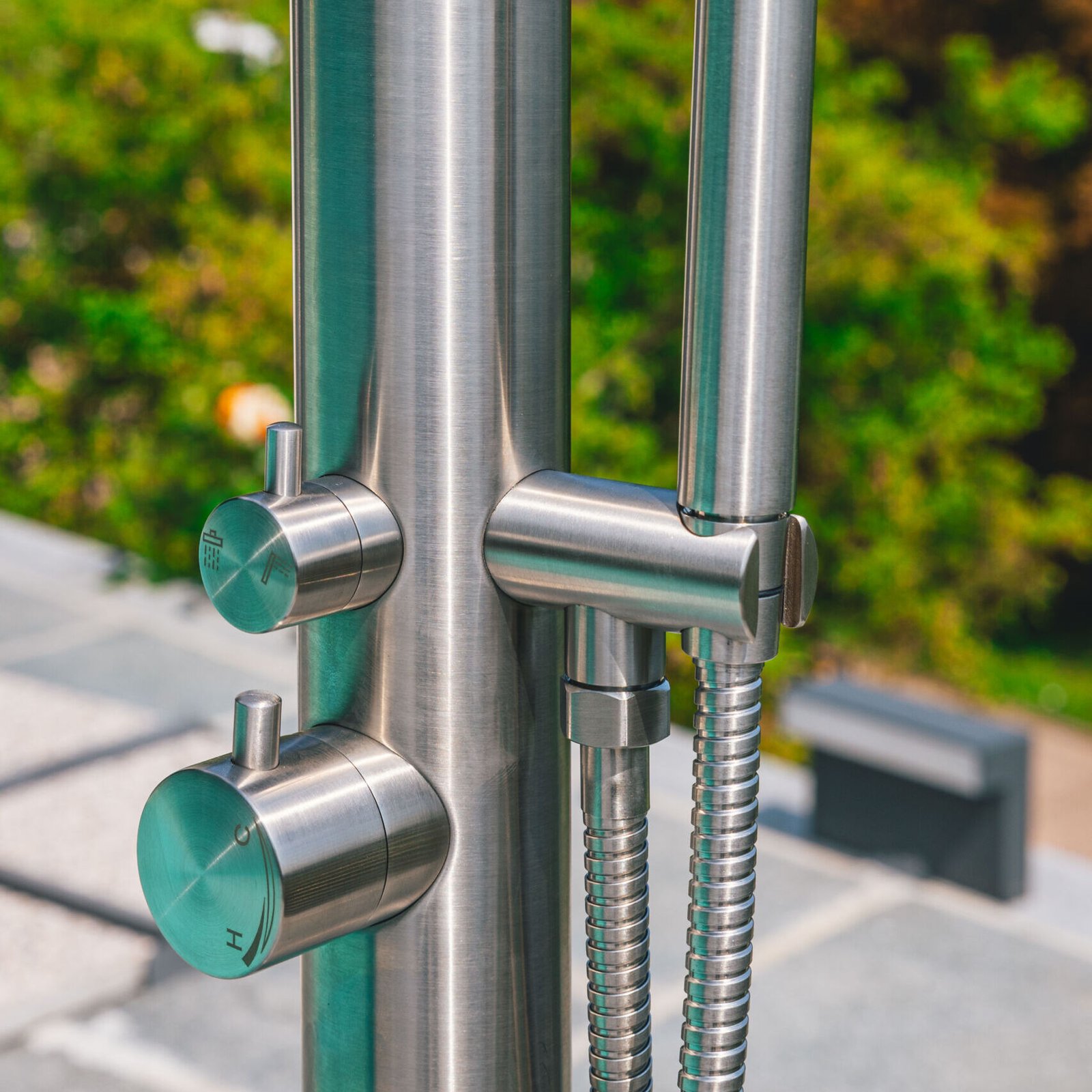 Durable marine-grade outdoor shower column, offering a sleek design with dual water flow control and a polished stainless steel finish