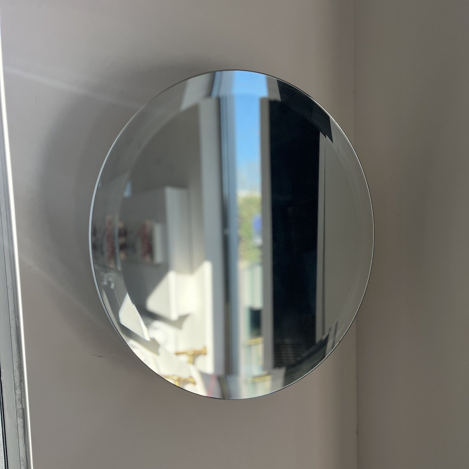 Front view of the ORBEO MIRROR towel warmer radiator—a round, modern wall-mounted mirror with sleek integrated towel hooks and a minimalist design.