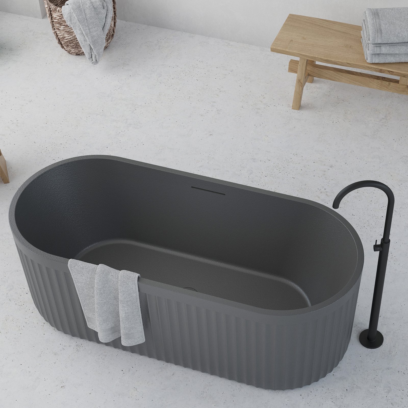 Ideavit Archtec freestanding bathtub in rock-textured cement grey finish Ideavit Archtec freestanding bathtub in rock-textured cement grey finish, shown with overflow and matching pop-up drain.