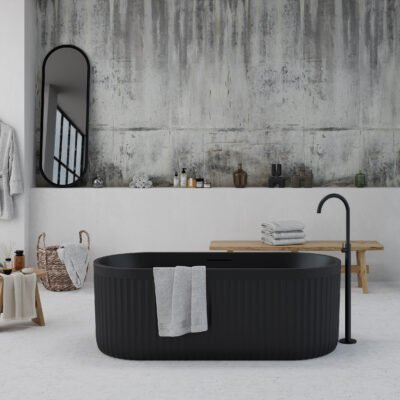 Freestanding black bathtub with textured ribbed exterior from Ideavit's ARCHTEC Collection, set in a minimalist bathroom.