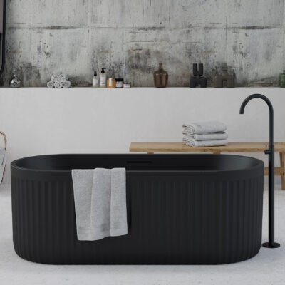 Freestanding black bathtub with textured ribbed exterior from Ideavit's ARCHTEC Collection, set in a minimalist bathroom.