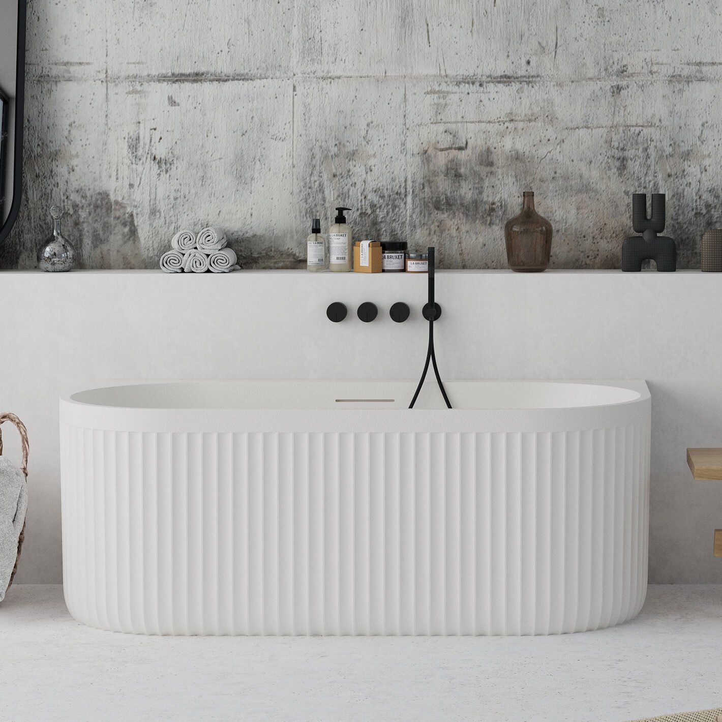 Back-to-wall white freestanding bathtub with ribbed stone-textured exterior from Ideavit’s ARCHTEC collection.