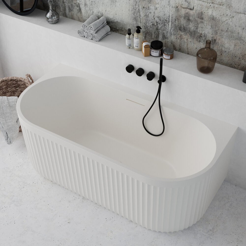 Modern white bathtub installed against the wall, showcasing a minimalist Rock Texture finish.
