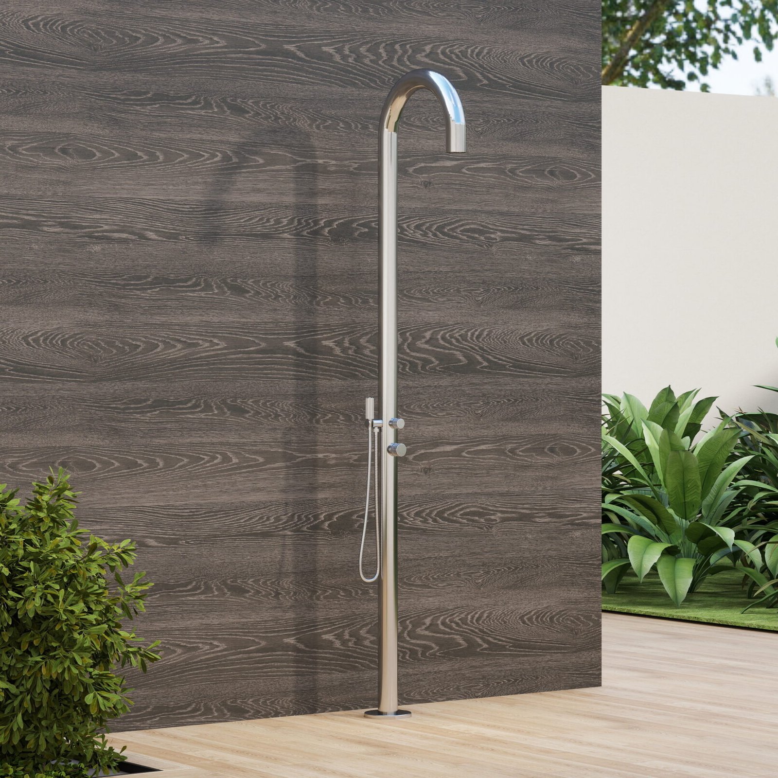 Stainless steel outdoor shower column with integrated overhead rain shower head, standing on a poolside patio surrounded by greenery.