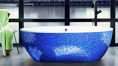 Sleek bathtub with a glossy white finish interior and exquisite Sicis blue leaf mosaic exterior
